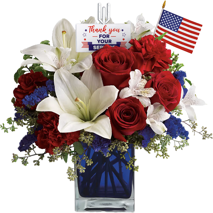 A patriotic flower arrangement with red roses, white lilies, and blue flowers in a blue vase. An American flag and a "Thank you for your service" card are inserted among the blooms.