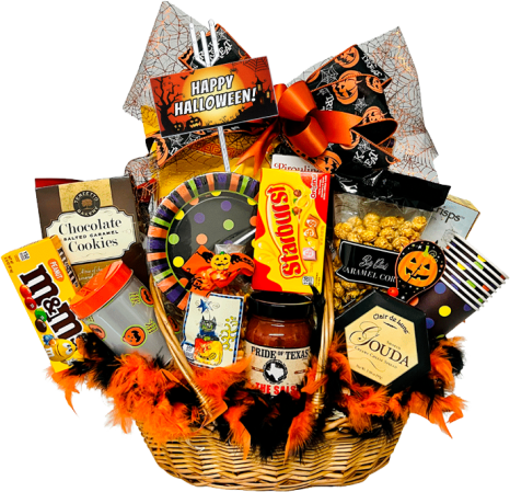 A Halloween-themed gift basket filled with assorted treats, including cookies, chips, chocolate candies, and popcorn. Decorated with orange and black ribbons, feathers, and spooky motifs. A "Happy Halloween" sign is prominently displayed.