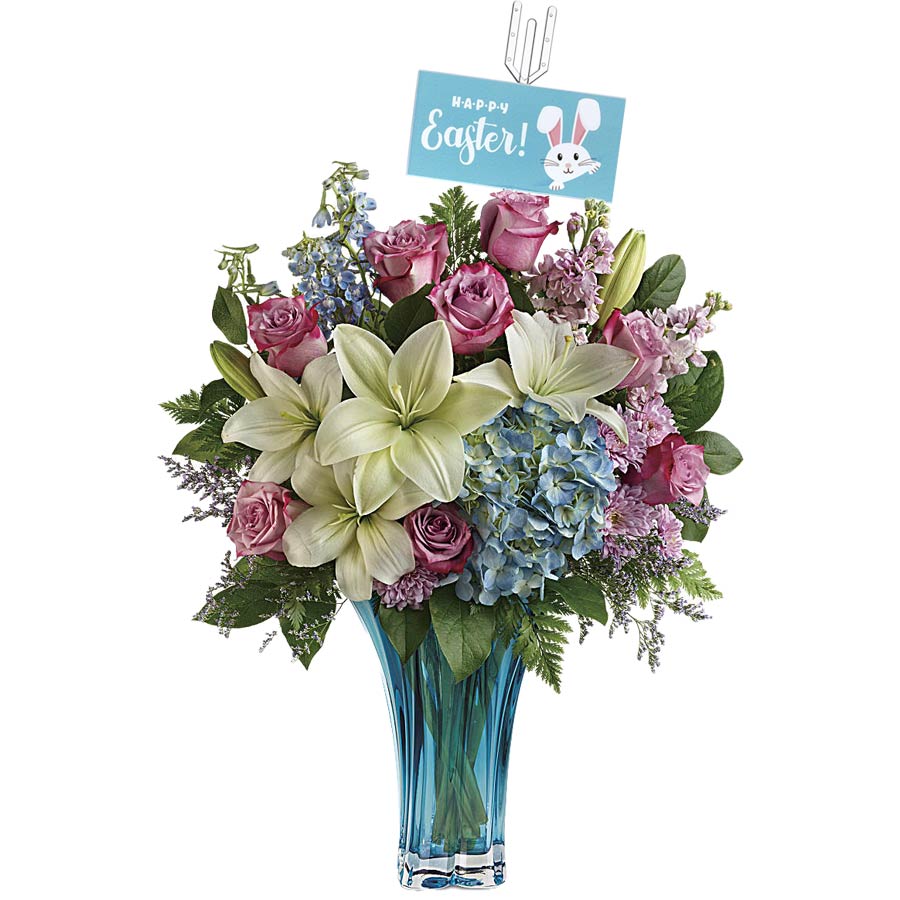 A vibrant floral arrangement in a blue vase features white lilies, pink roses, and blue hydrangeas, surrounded by greenery. A card with "Happy Easter!" and a cute bunny is attached above the flowers.