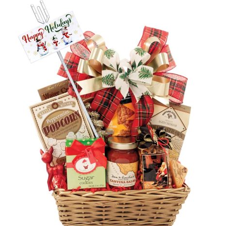 A festive holiday gift basket filled with assorted treats like popcorn, salsa, sugar cookies, and cheeses. It's adorned with a red and gold ribbon and a card reading "Happy Holidays" with snowmen illustrations.