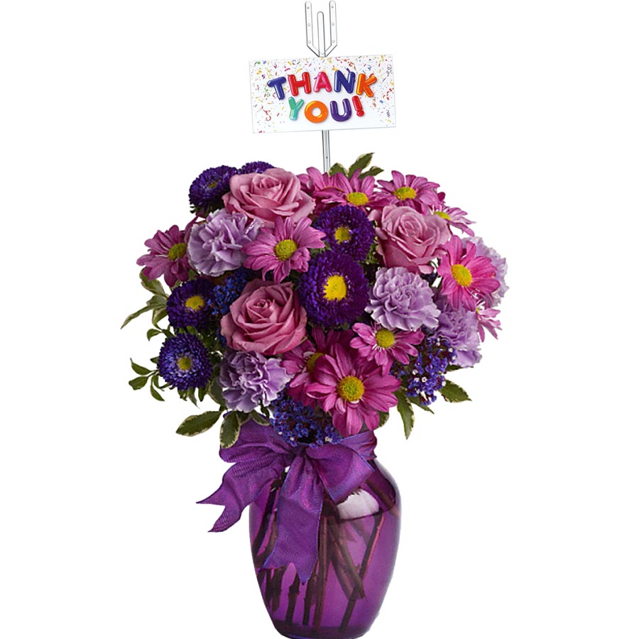 A vibrant bouquet of purple and pink flowers in a purple vase, adorned with a purple bow. A cheerful "Thank You" card sits atop, featuring colorful letters and decorative confetti accents.